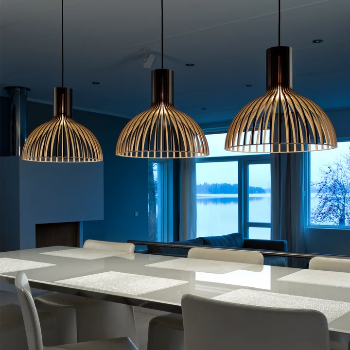 Die Victo Small 4251 Pendelleuchte von Secto über einem langen, weißen Esstisch